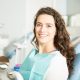 portrait-smiling-young-woman-sitting-chair-dental-clinic