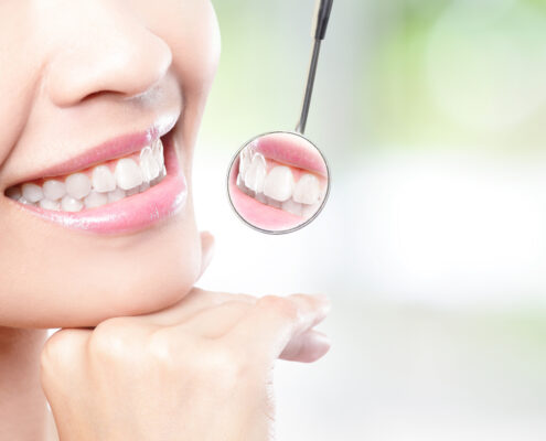 Healthy woman teeth and dentist mouth mirror