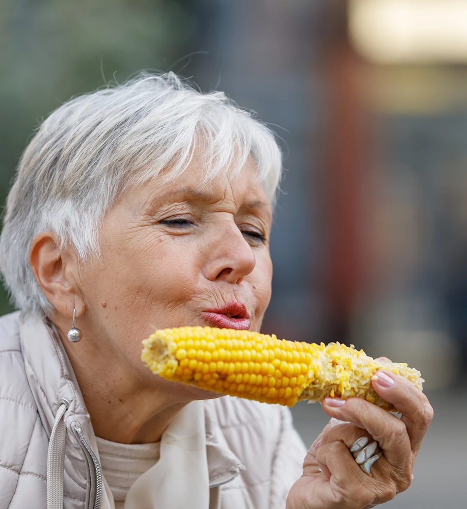 old women eating corn